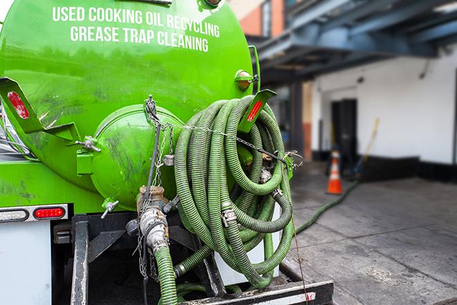 a grease trap pumping truck at a restaurant in Boston